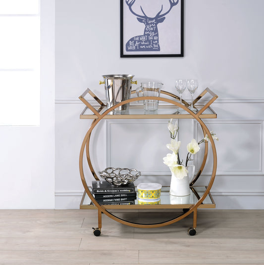 Benzara BM194342 Gold and Clear Metal Serving Cart With Mirrored Open Shelf and Tubular Angled Handles