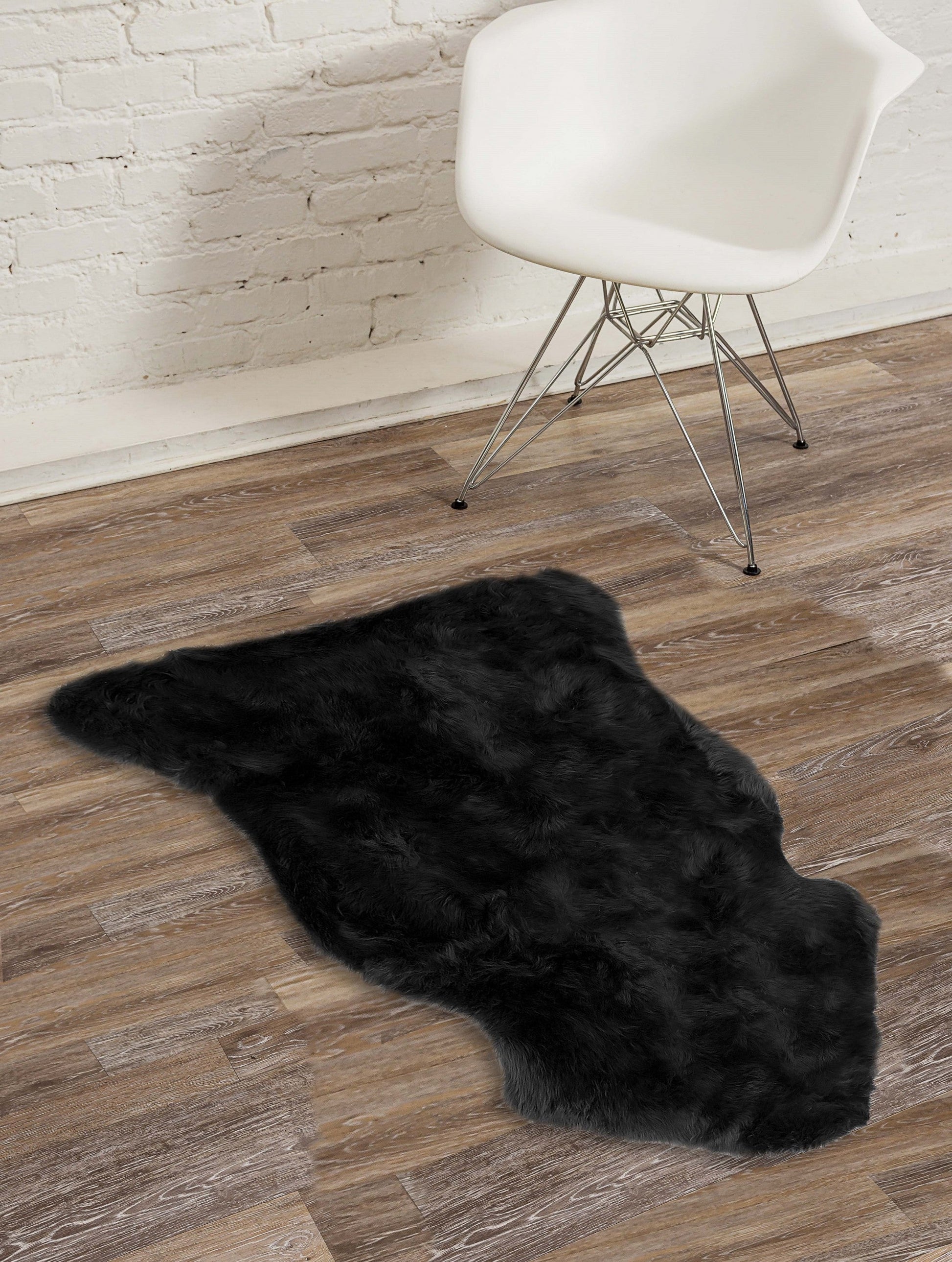 HomeRoots 24" x 36" x 1.5" Single Sheepskin Area Rug in Black Finish