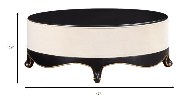 HomeRoots 47" x 47" x 19" Cream Fabric And Black Wood Cocktail Table With Upholstered Base