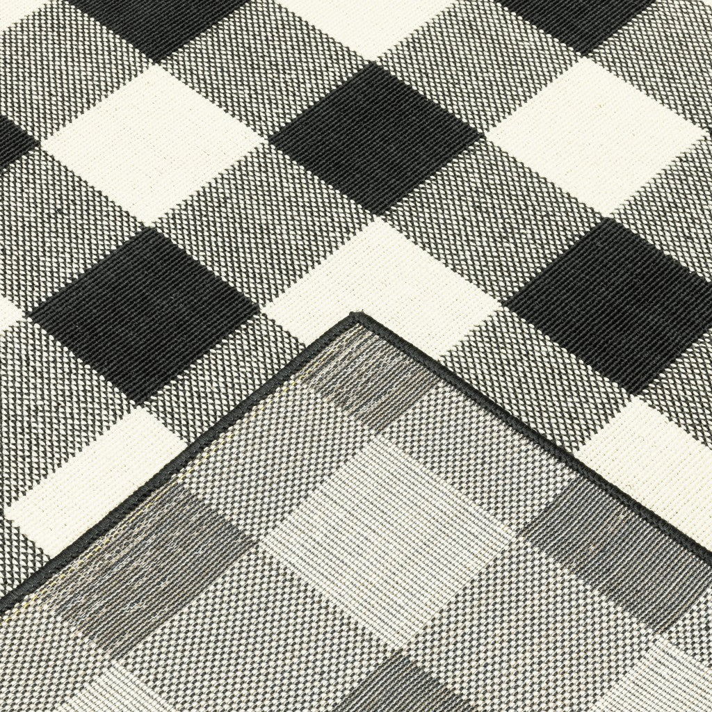 HomeRoots 8’ Round Black and Ivory Gingham Indoor Outdoor Area Rug
