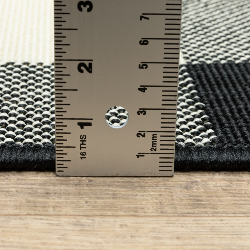 HomeRoots 8’ Round Black and Ivory Gingham Indoor Outdoor Area Rug