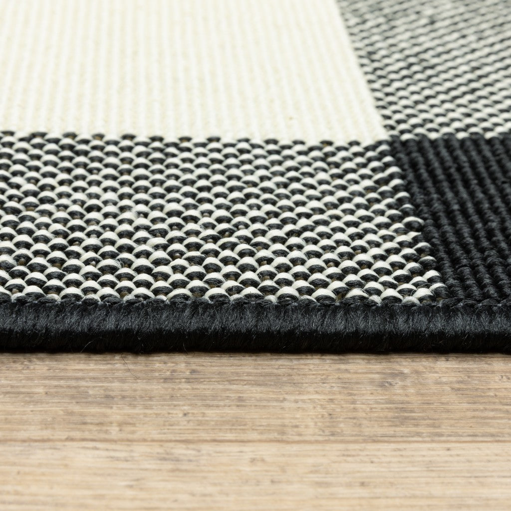 HomeRoots 8’ Round Black and Ivory Gingham Indoor Outdoor Area Rug