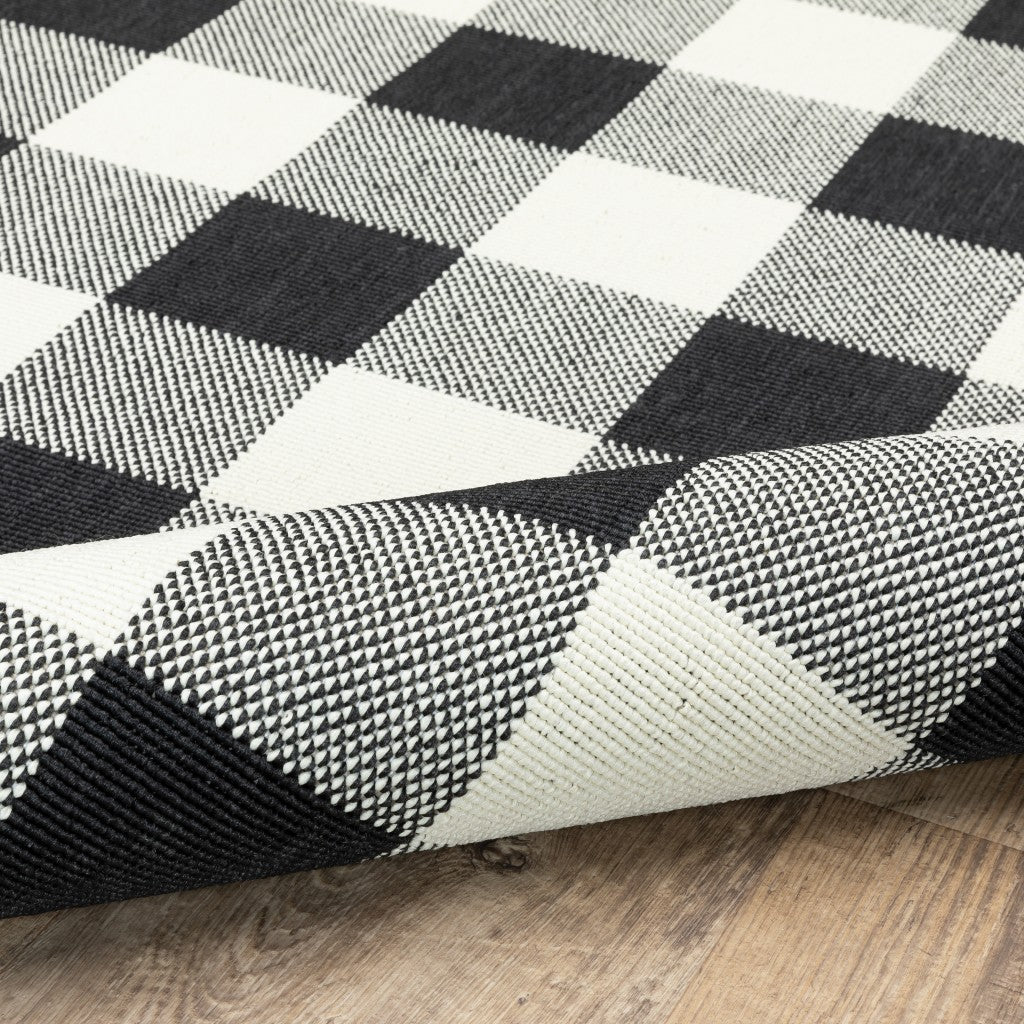 HomeRoots 8’ Round Black and Ivory Gingham Indoor Outdoor Area Rug
