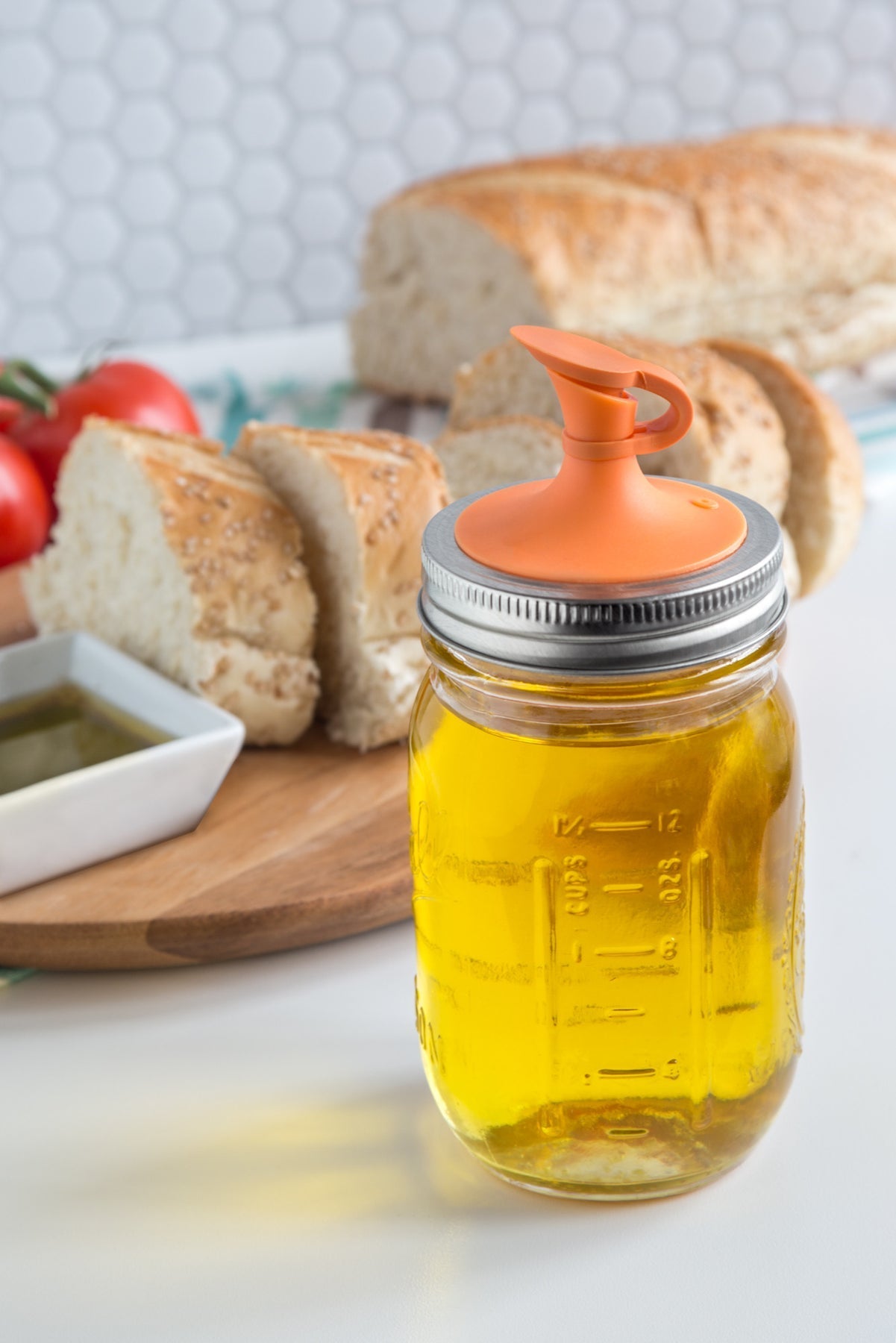 https://kitchenoasis.com/cdn/shop/files/Jarware-Oil-Cruet-Lid-with-No-Drip-Spout-For-Regular-Mouth-Mason-Jars-Orange-2.jpg?v=1702084520&width=1445