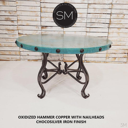 Mexports by Susana Molina 54" x 30" Oxidized Hammer Copper Top With Nailheads and 4-Leg Iron Base Round Dining Table