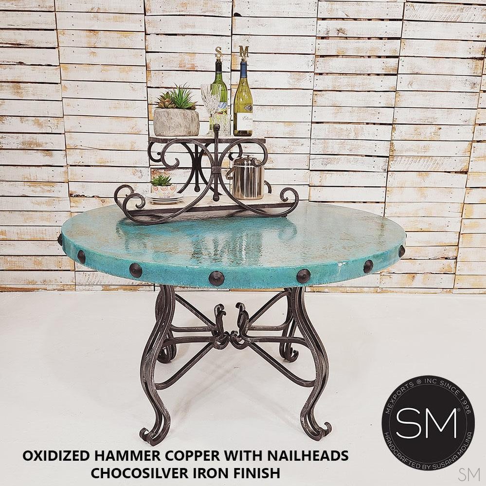 Mexports by Susana Molina 60" x 30" Oxidized Hammer Copper Top With Nailheads and 4-Leg Iron Base Round Dining Table